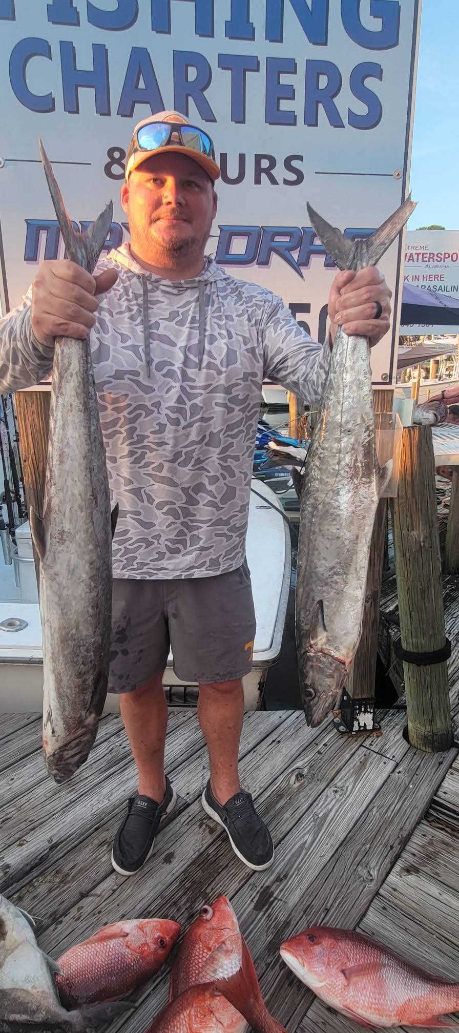 Angler with king mackerel and snapper at his feet