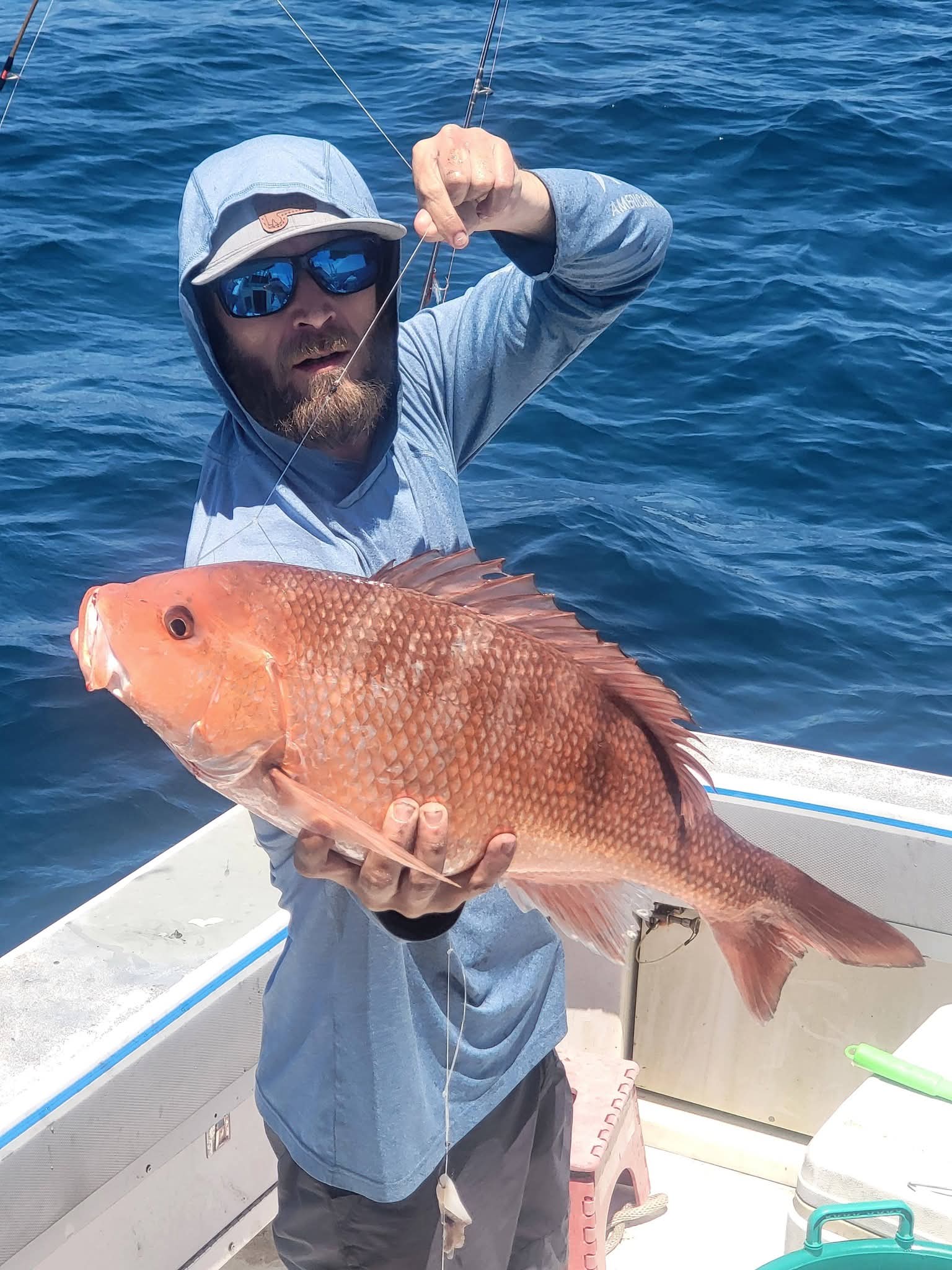 Red snapper catch with blue Gulf water behind
