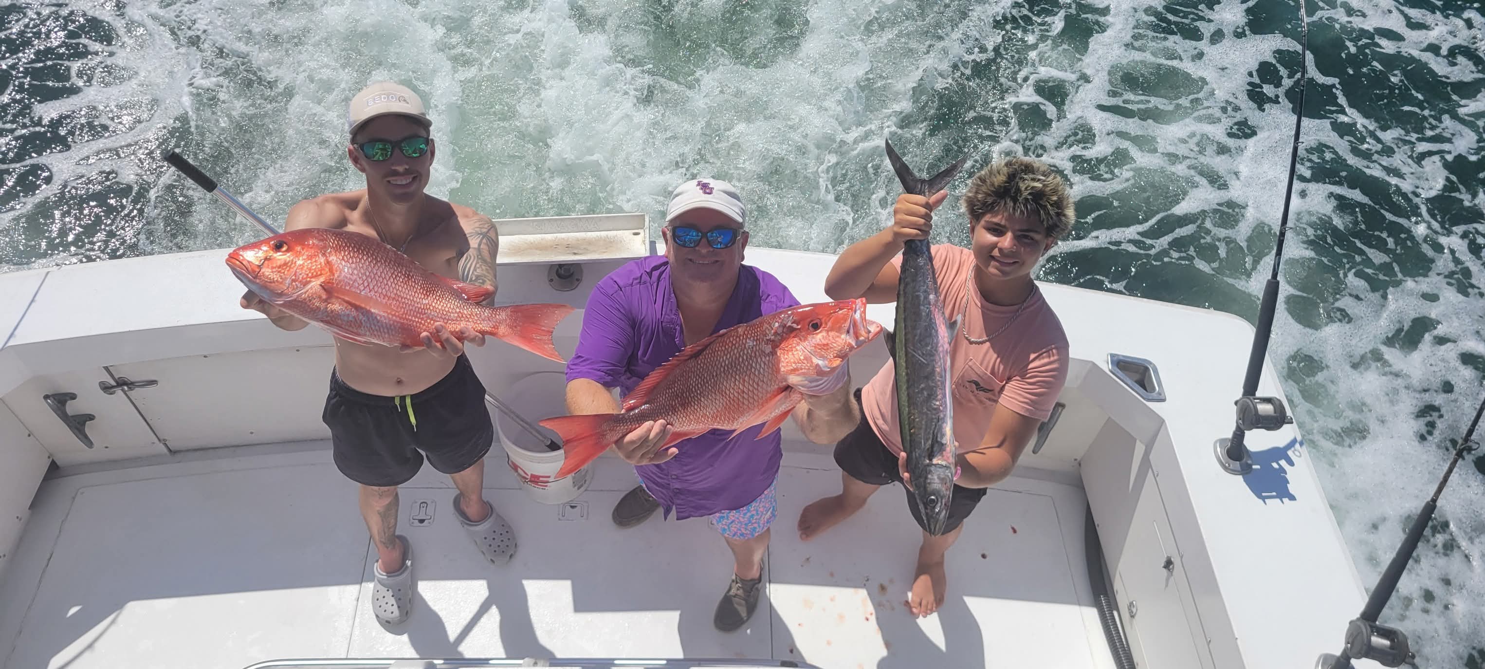 Anglers showing off their catch on a Dirty Monkey charter